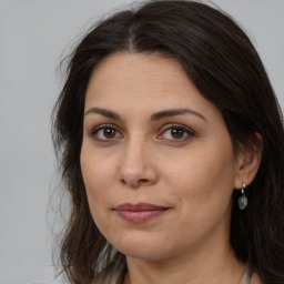 Joyful white adult female with long  brown hair and brown eyes