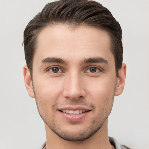 Joyful white young-adult male with short  brown hair and brown eyes