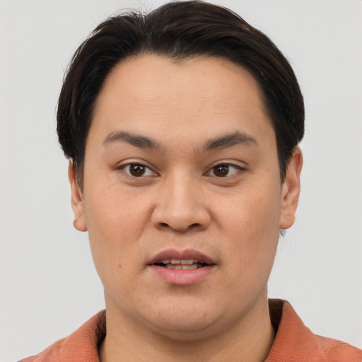 Joyful asian young-adult male with short  brown hair and brown eyes
