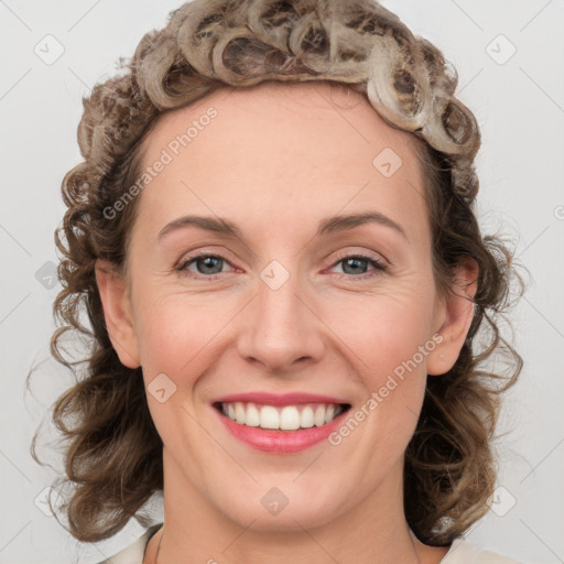 Joyful white adult female with medium  brown hair and blue eyes