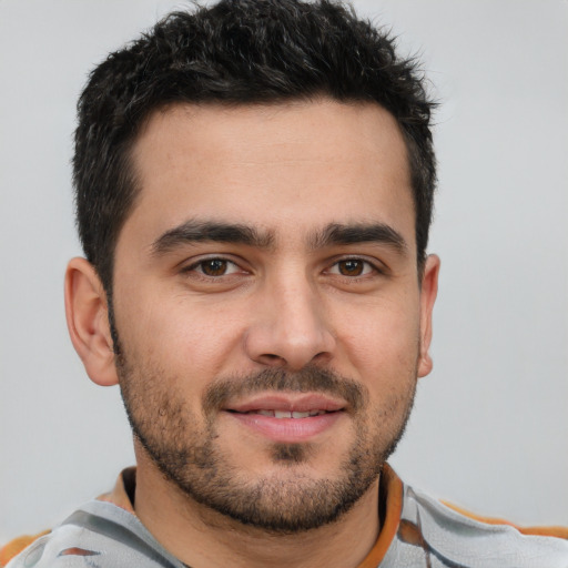 Joyful white young-adult male with short  brown hair and brown eyes