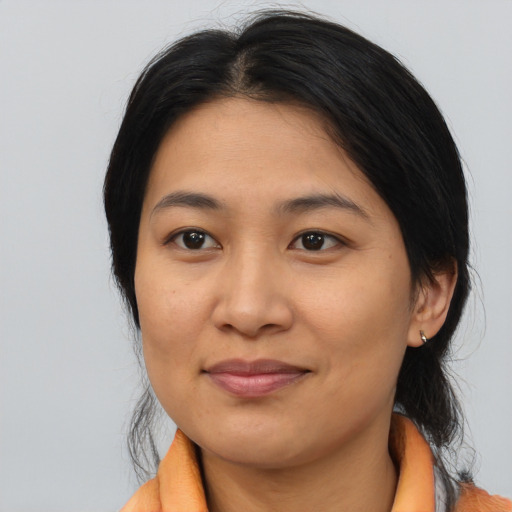 Joyful asian young-adult female with medium  brown hair and brown eyes