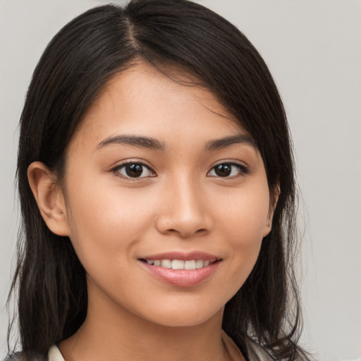 Joyful white young-adult female with long  brown hair and brown eyes