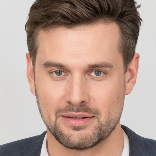 Joyful white young-adult male with short  brown hair and brown eyes