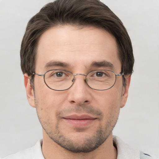 Joyful white adult male with short  brown hair and grey eyes