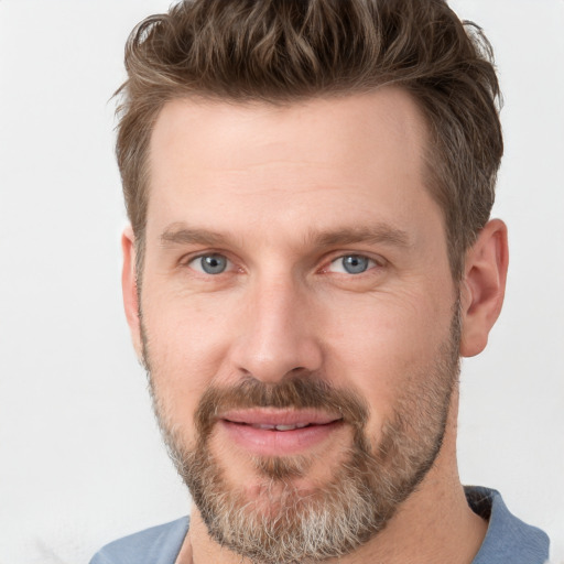 Joyful white adult male with short  brown hair and grey eyes