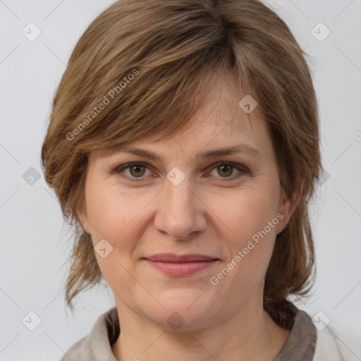 Joyful white adult female with medium  brown hair and grey eyes