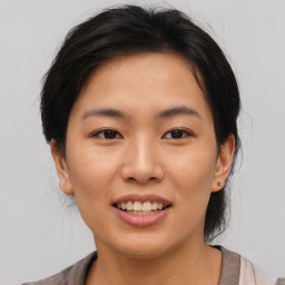 Joyful asian young-adult female with medium  brown hair and brown eyes