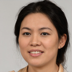 Joyful white young-adult female with medium  brown hair and brown eyes