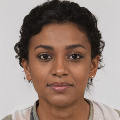 Joyful latino young-adult female with short  brown hair and brown eyes