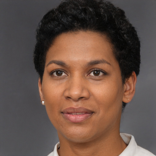 Joyful black adult female with short  black hair and brown eyes
