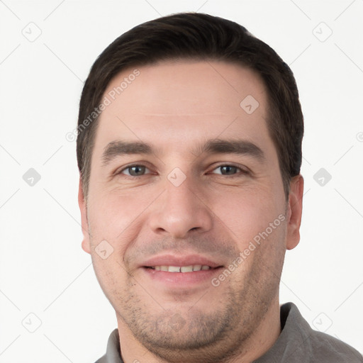 Joyful white young-adult male with short  brown hair and brown eyes