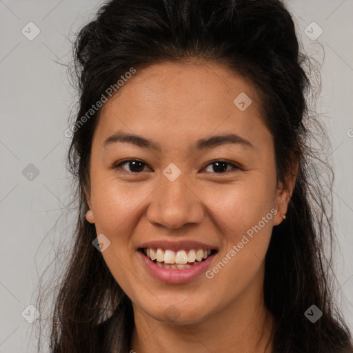 Joyful latino young-adult female with long  brown hair and brown eyes