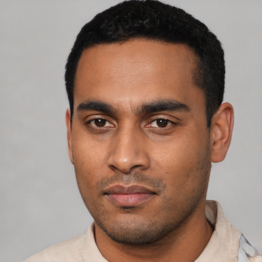 Joyful latino young-adult male with short  black hair and brown eyes