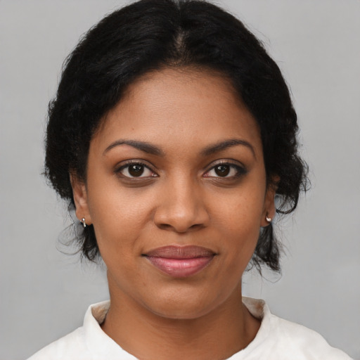 Joyful black young-adult female with medium  brown hair and brown eyes