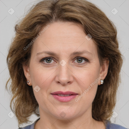 Joyful white adult female with medium  brown hair and green eyes