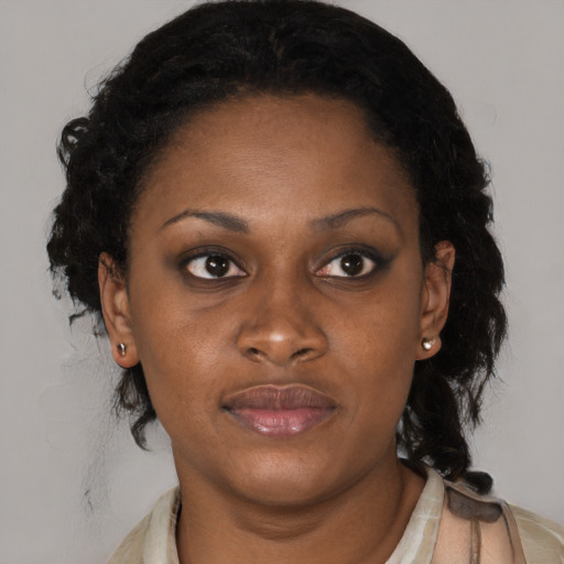 Joyful black young-adult female with medium  brown hair and brown eyes
