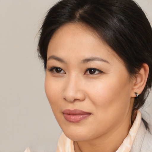 Joyful asian young-adult female with medium  brown hair and brown eyes