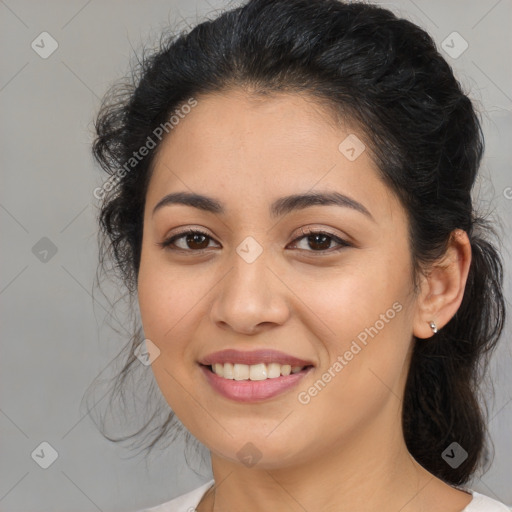 Joyful latino young-adult female with medium  brown hair and brown eyes