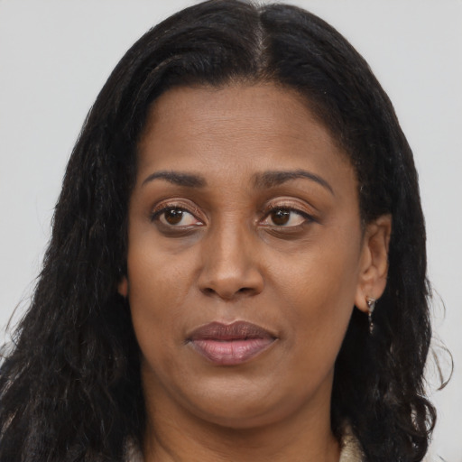 Joyful latino adult female with long  brown hair and brown eyes