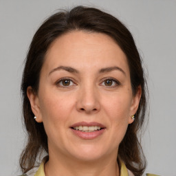 Joyful white adult female with medium  brown hair and brown eyes