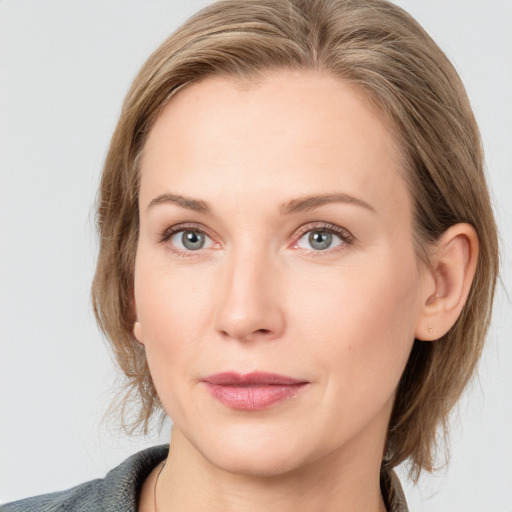 Joyful white young-adult female with medium  brown hair and blue eyes