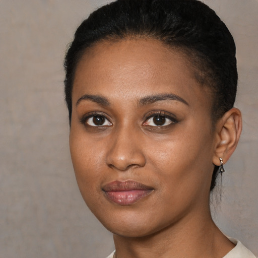 Joyful black young-adult female with short  brown hair and brown eyes