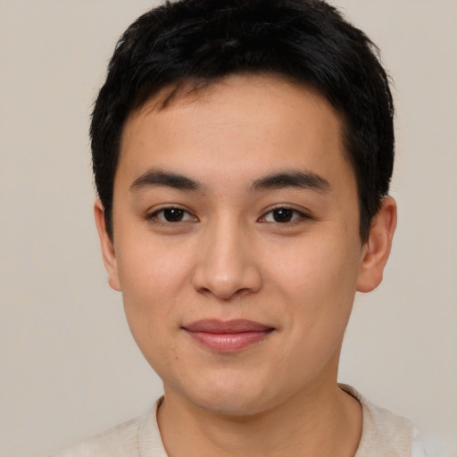 Joyful asian young-adult male with short  black hair and brown eyes