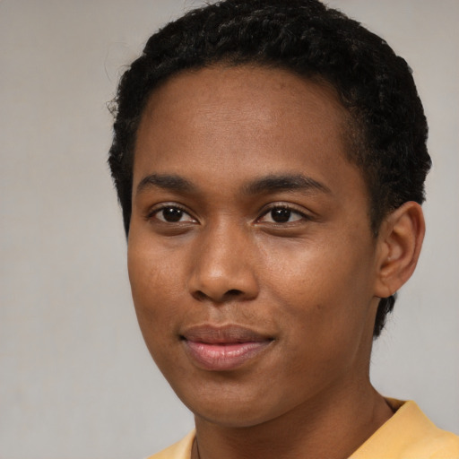 Joyful black young-adult male with short  brown hair and brown eyes