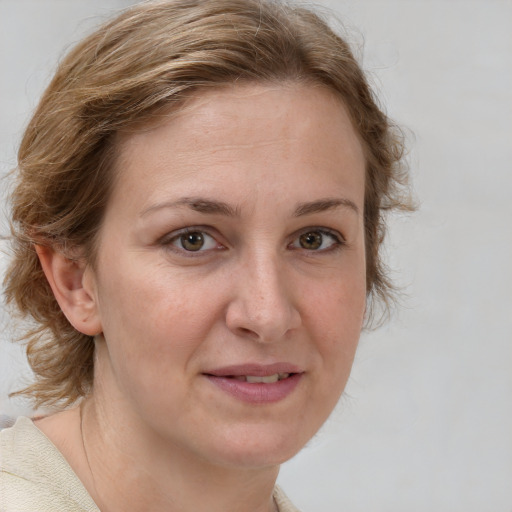 Joyful white adult female with medium  brown hair and grey eyes