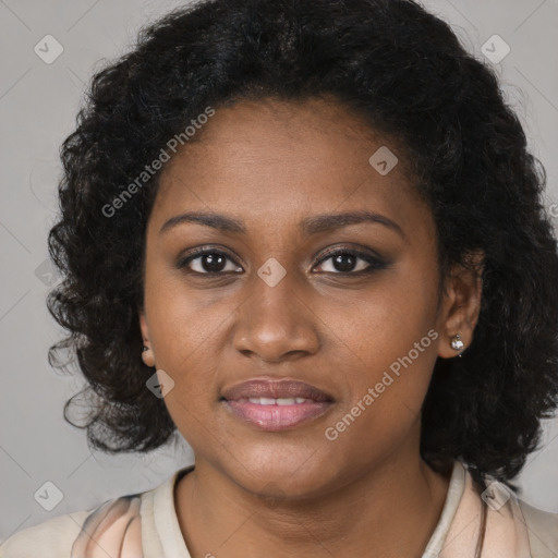 Joyful black young-adult female with long  black hair and brown eyes