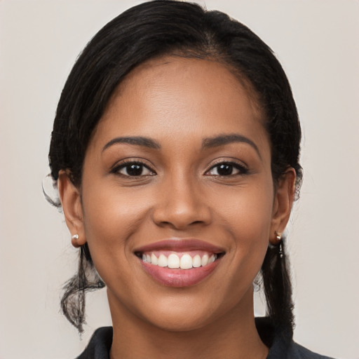 Joyful black young-adult female with medium  brown hair and brown eyes