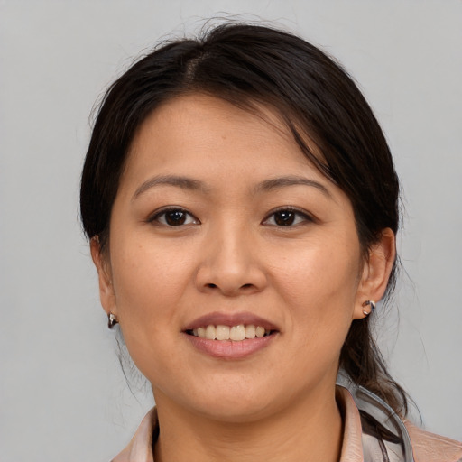 Joyful white young-adult female with medium  brown hair and brown eyes