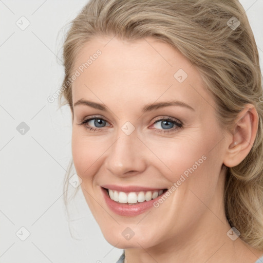 Joyful white young-adult female with medium  brown hair and blue eyes