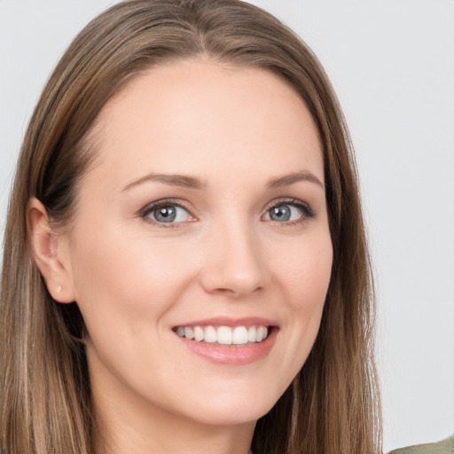 Joyful white young-adult female with long  brown hair and grey eyes