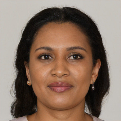 Joyful black young-adult female with medium  brown hair and brown eyes
