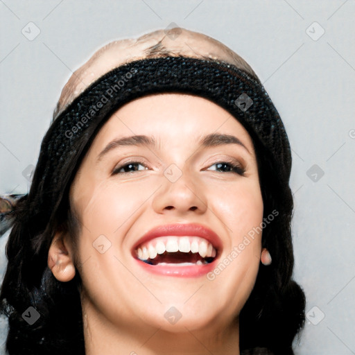 Joyful white young-adult female with long  black hair and brown eyes