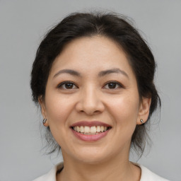 Joyful asian young-adult female with medium  brown hair and brown eyes