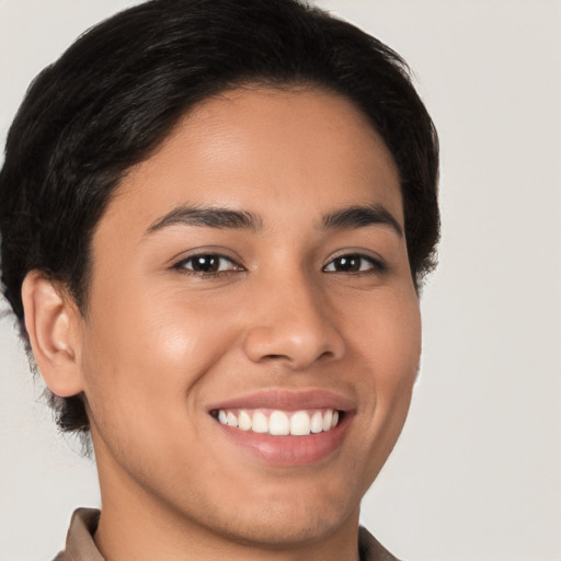 Joyful latino young-adult male with short  brown hair and brown eyes