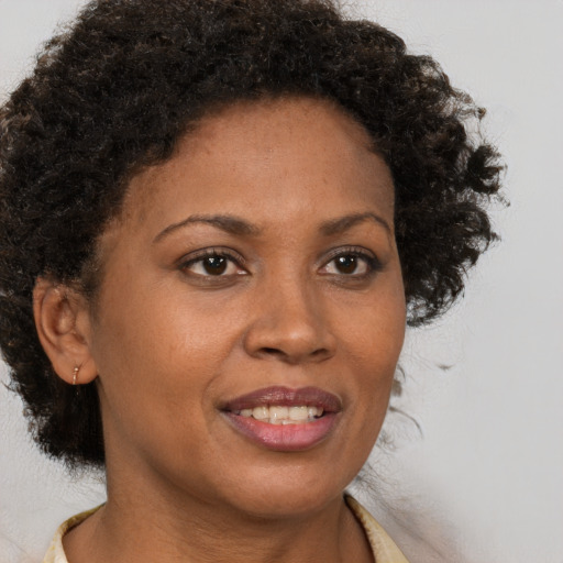Joyful black adult female with short  brown hair and brown eyes