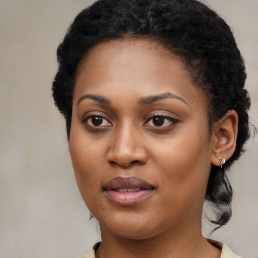 Joyful black young-adult female with medium  black hair and brown eyes