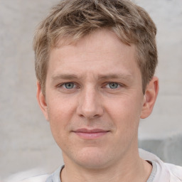 Joyful white adult male with short  brown hair and grey eyes