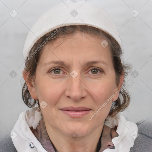 Joyful white adult female with medium  brown hair and blue eyes