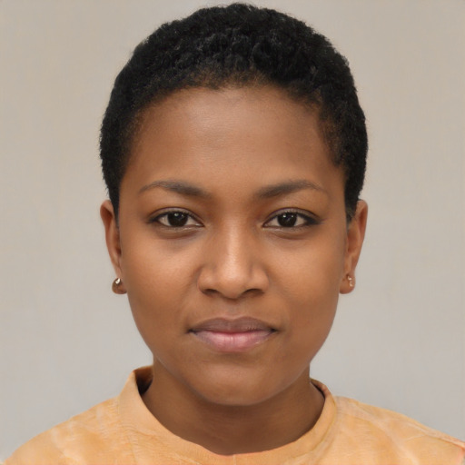 Joyful black young-adult female with short  black hair and brown eyes
