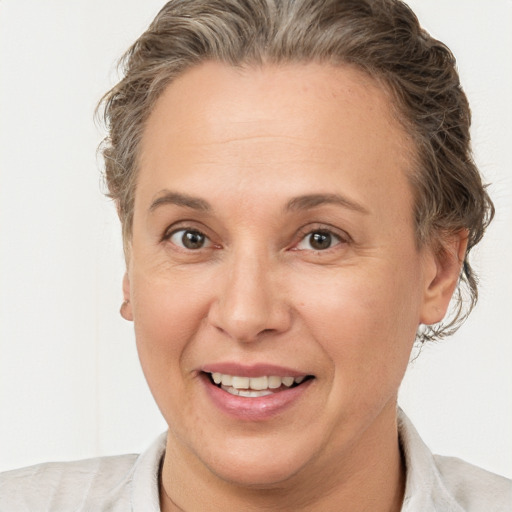 Joyful white adult female with short  brown hair and brown eyes