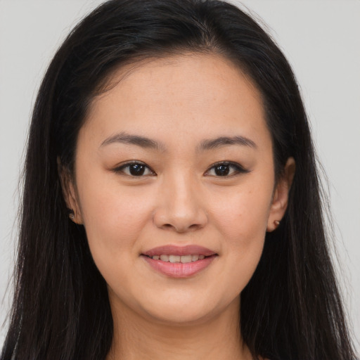 Joyful asian young-adult female with long  brown hair and brown eyes