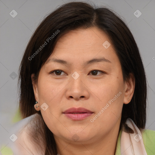 Joyful asian adult female with medium  brown hair and brown eyes