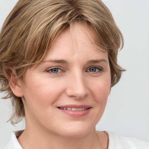 Joyful white young-adult female with medium  brown hair and blue eyes