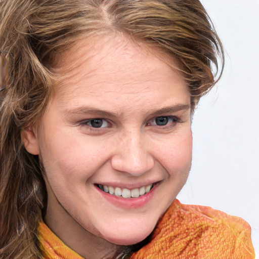 Joyful white young-adult female with long  brown hair and blue eyes