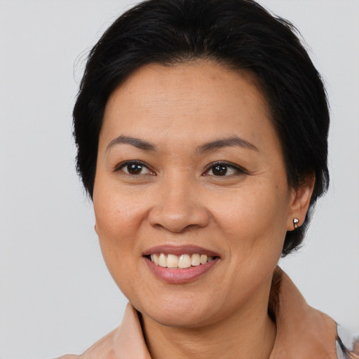 Joyful asian adult female with medium  brown hair and brown eyes